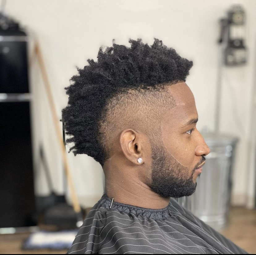 Curly mohawk with a high skin fade and sharp line-up at To the Nines Barbershop